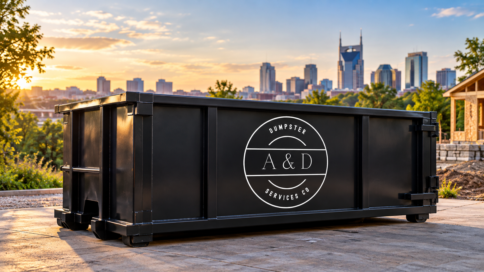 Black A&D roll-off dumpster in front of the Nashville skyline at sunset