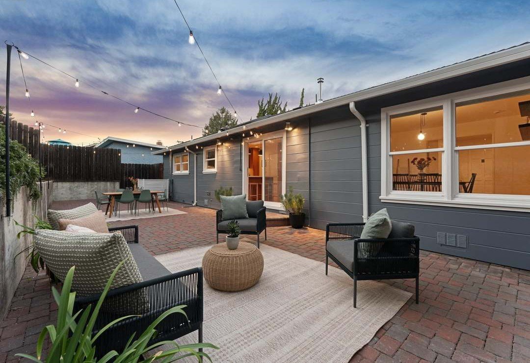 Sterling Drive patio at twilight, lounge along the house under string lights