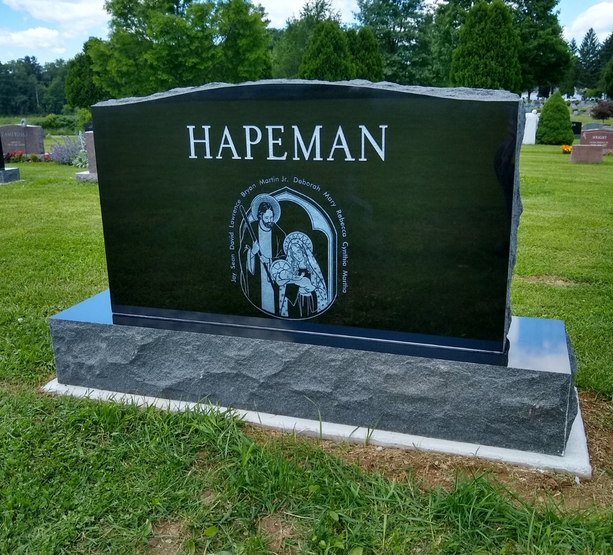 Polished green granite monument with an etched portrait