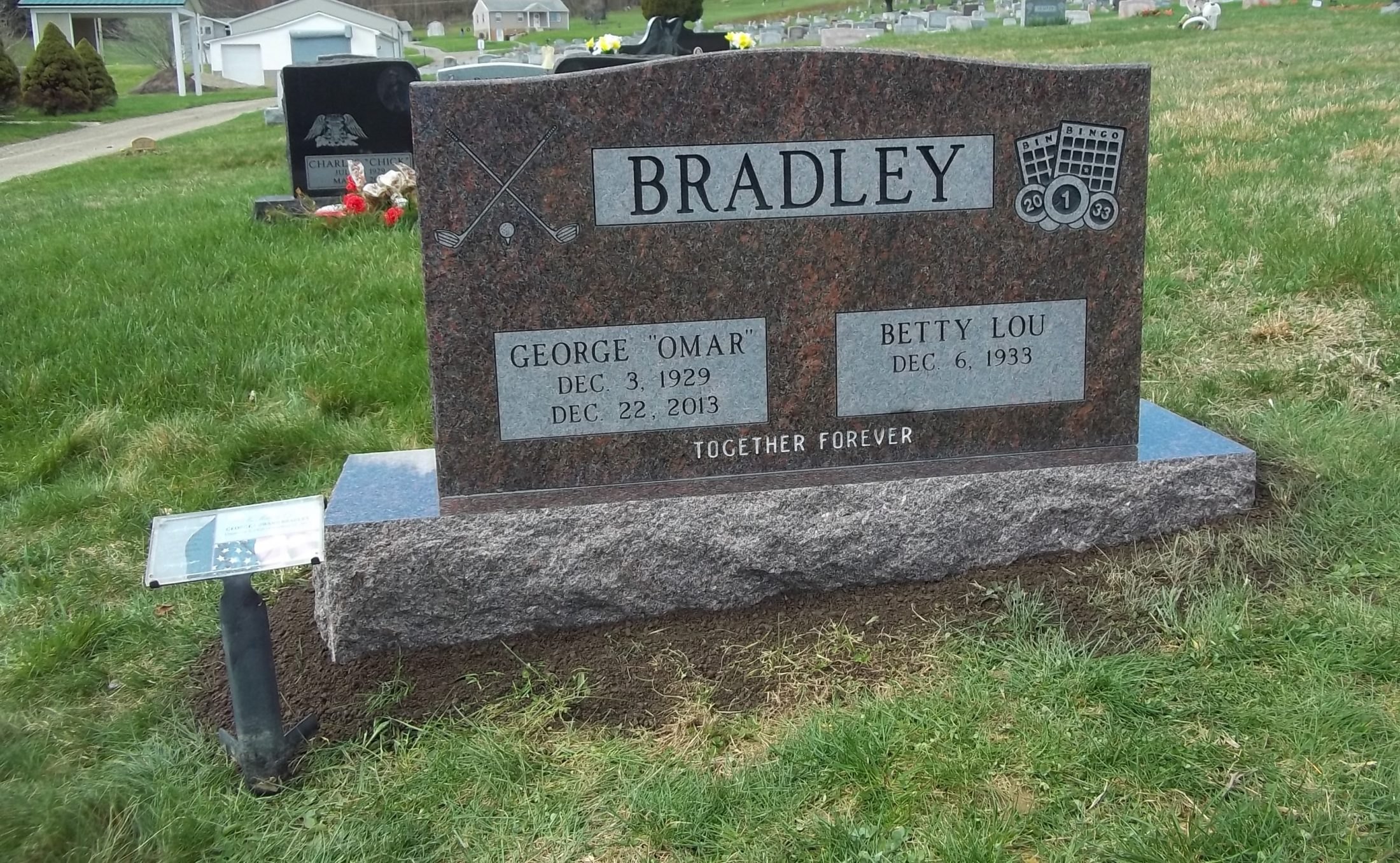 Red granite upright monument in a cemetery