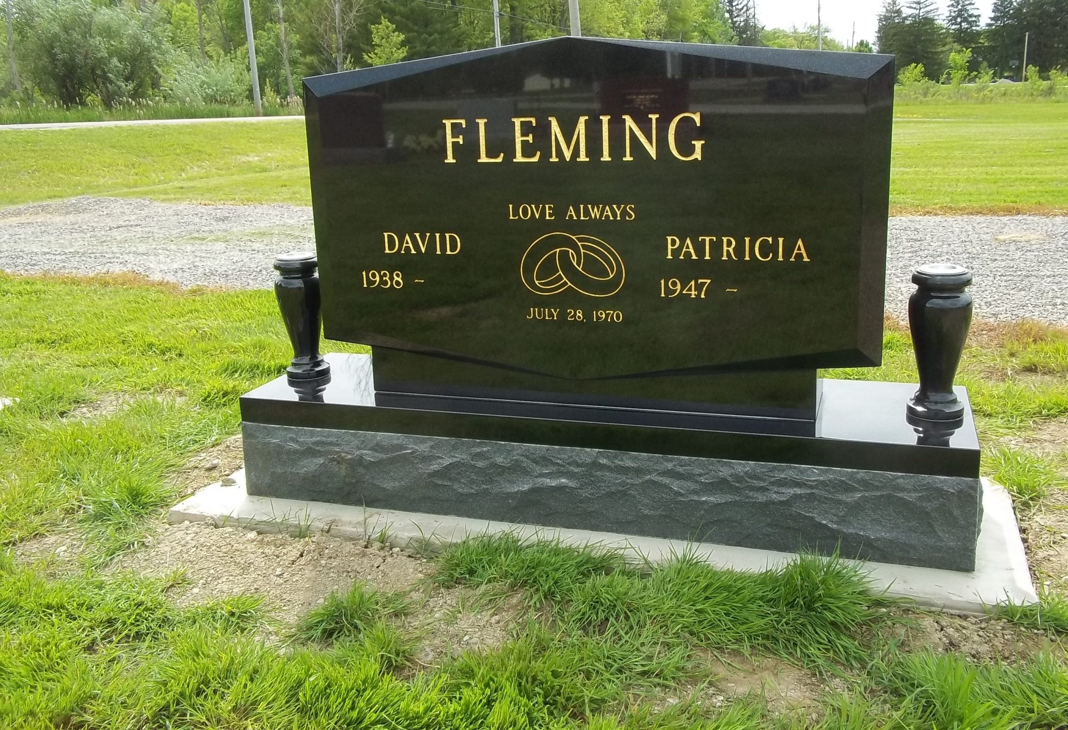 Black granite upright monument with a gold-leaf name