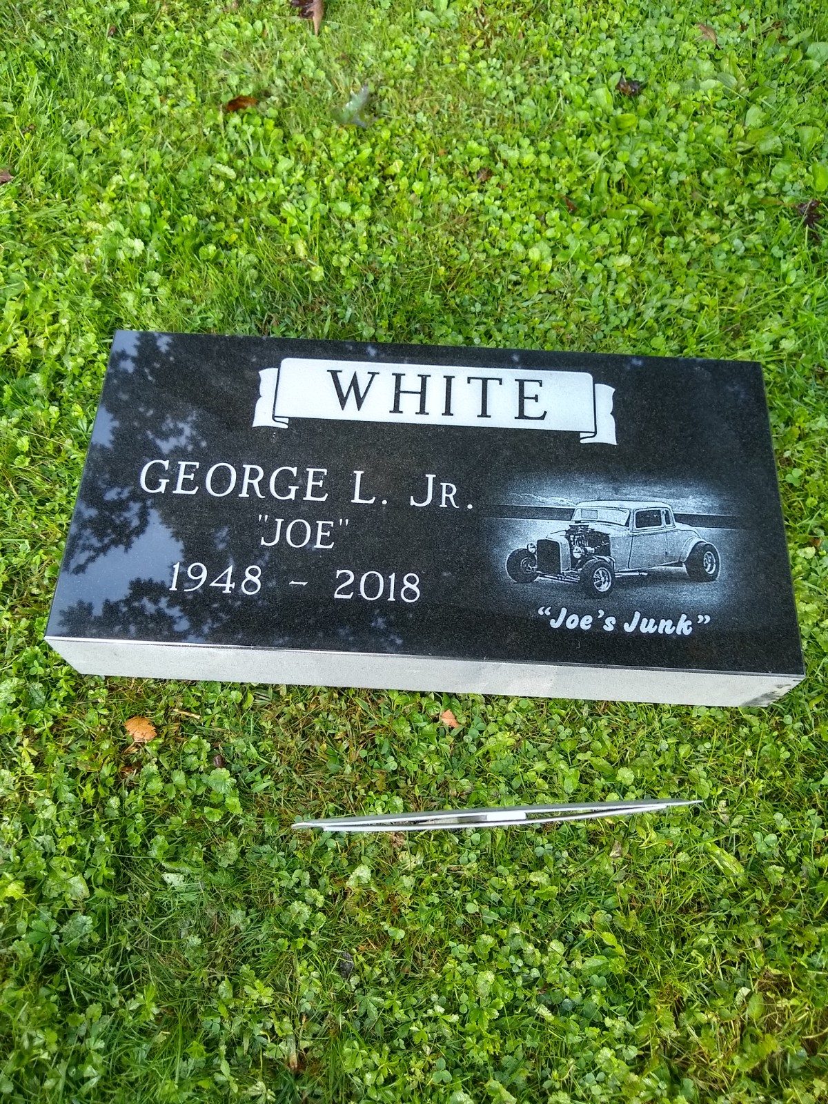 Black granite flush marker with an etched portrait