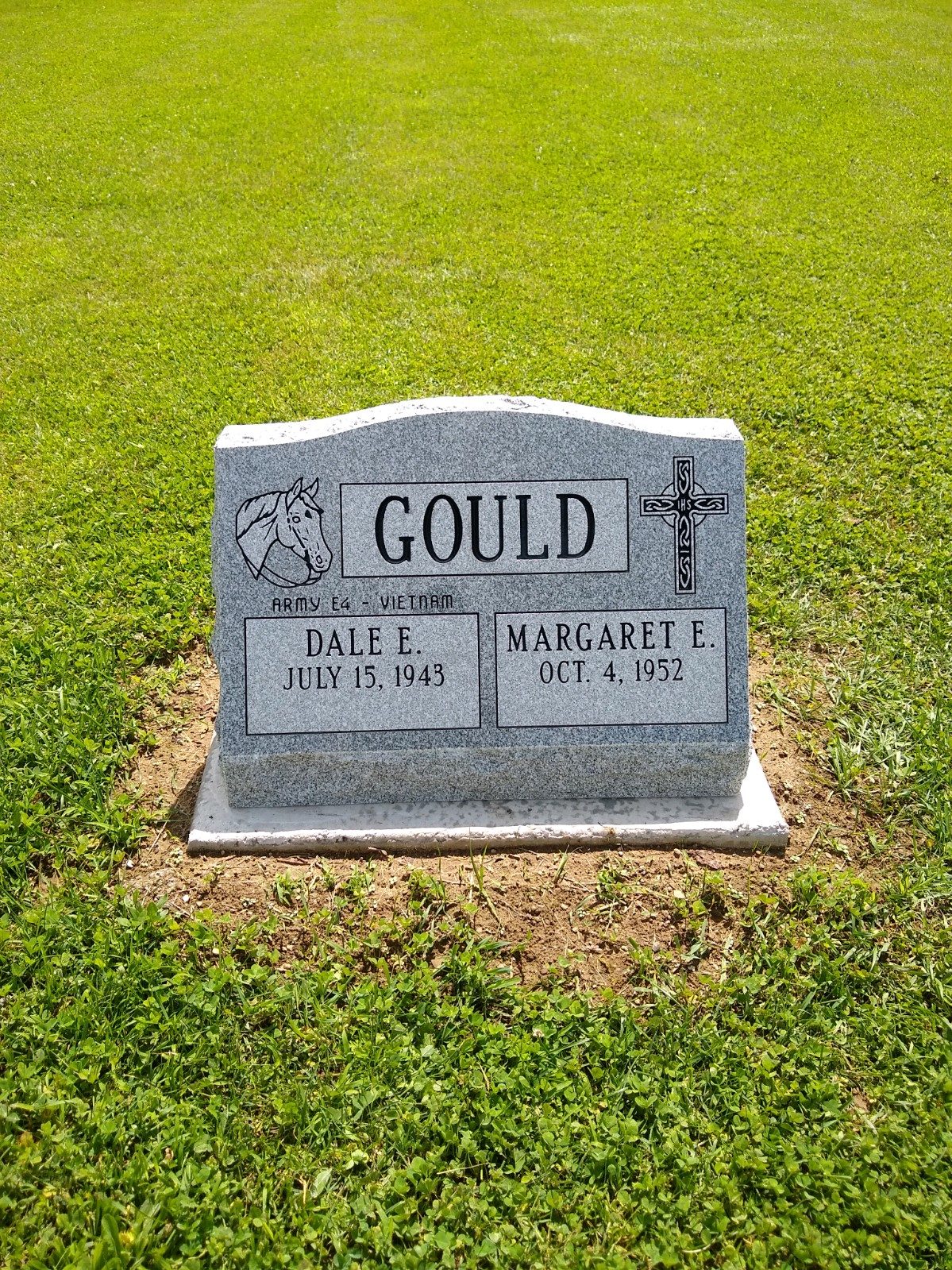 Grey granite slant marker with a carved cross