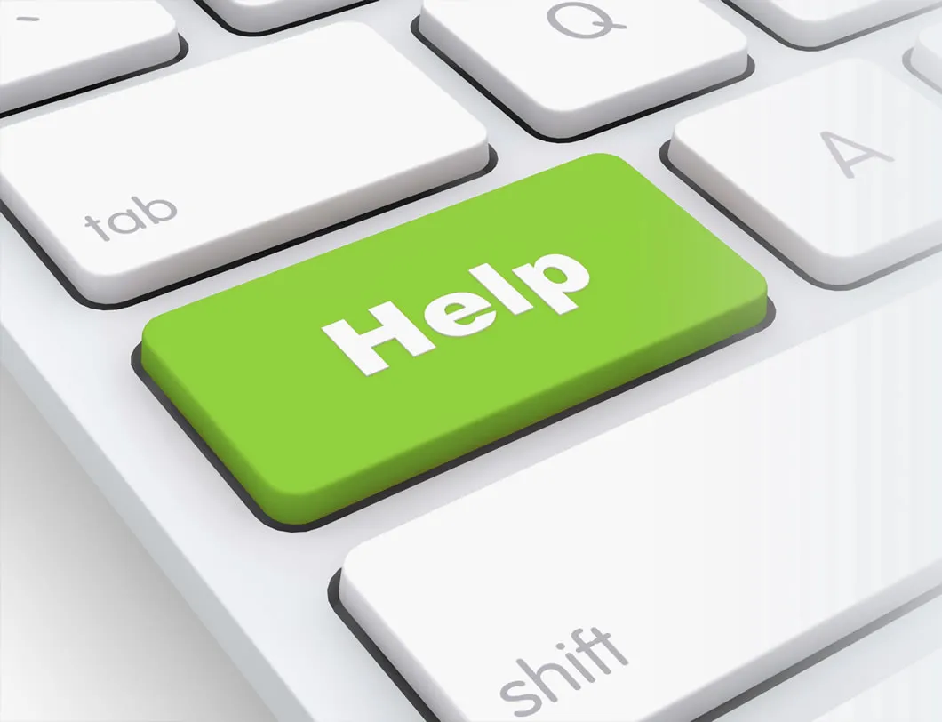 A green Help key on a white keyboard