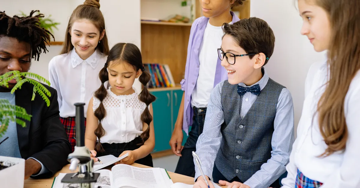 Students gathered around a microscope in a classroom
