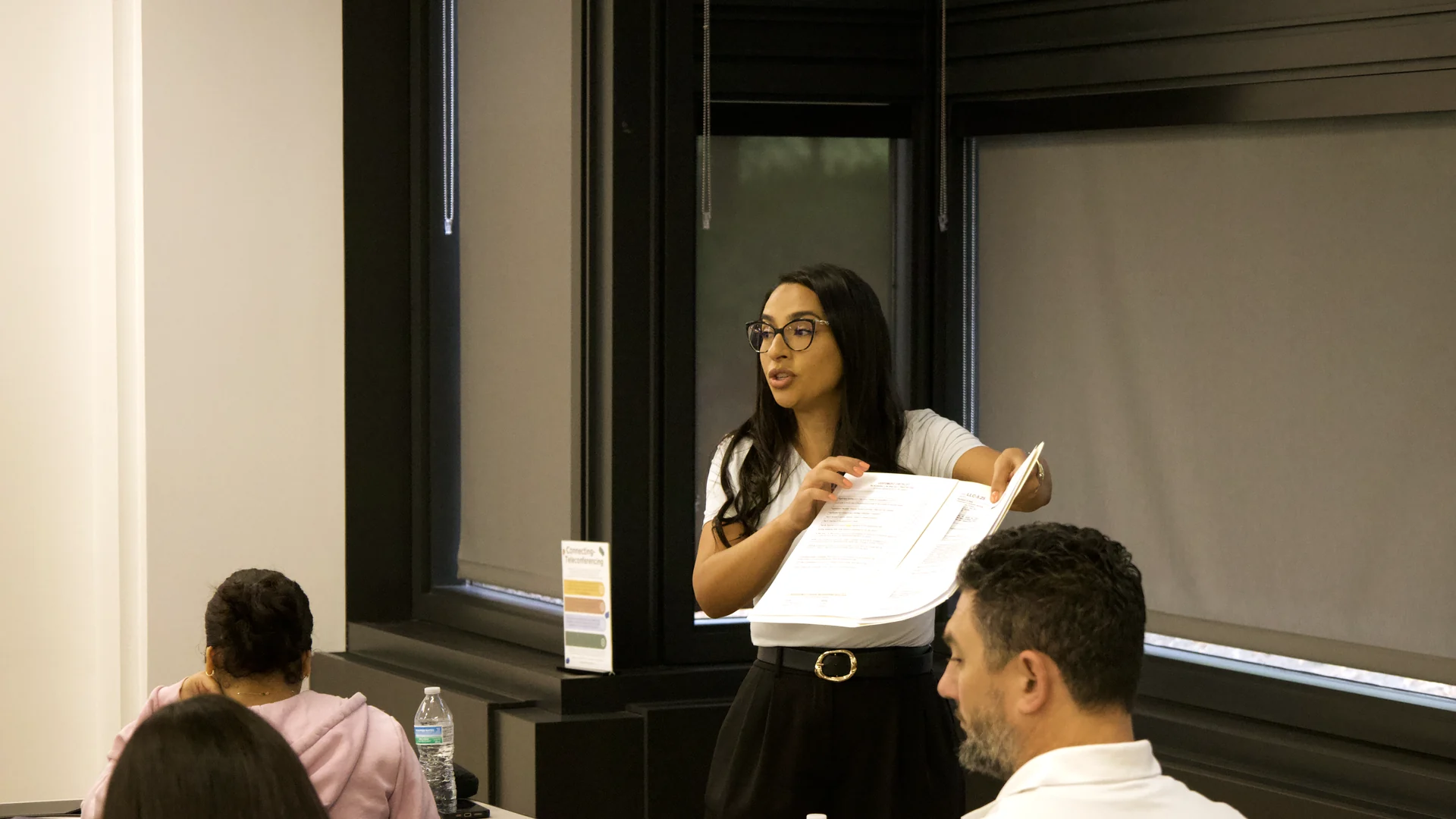 Dalia Doherty walking an Illinois public adjuster class through a handout