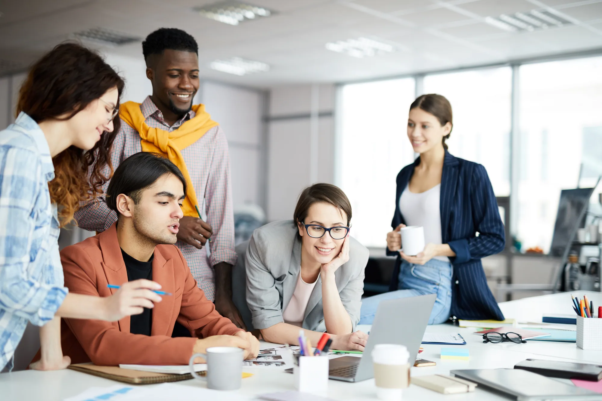 Marketing team reviewing analytics on a laptop