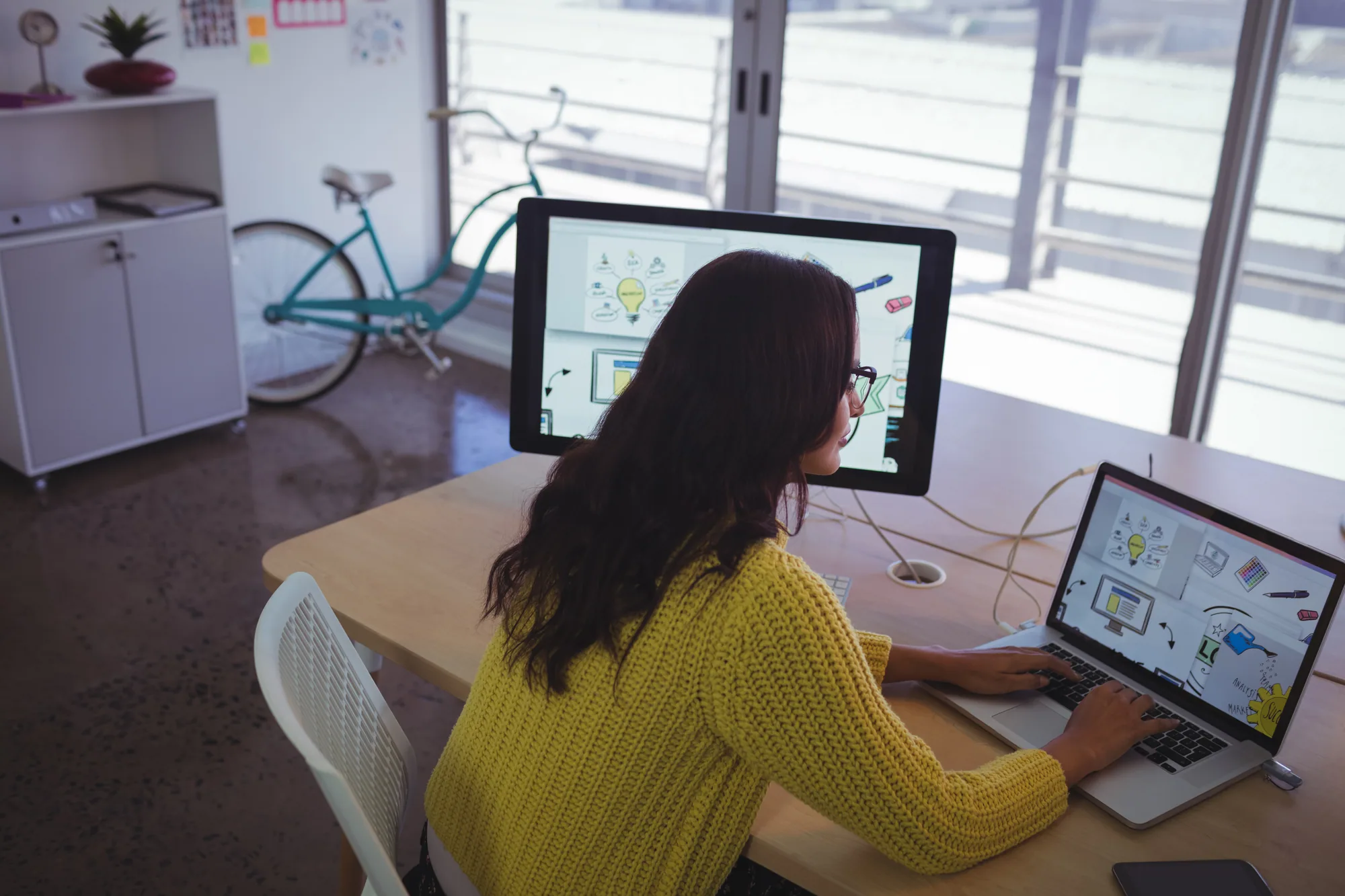 Digital strategist working at a computer workstation