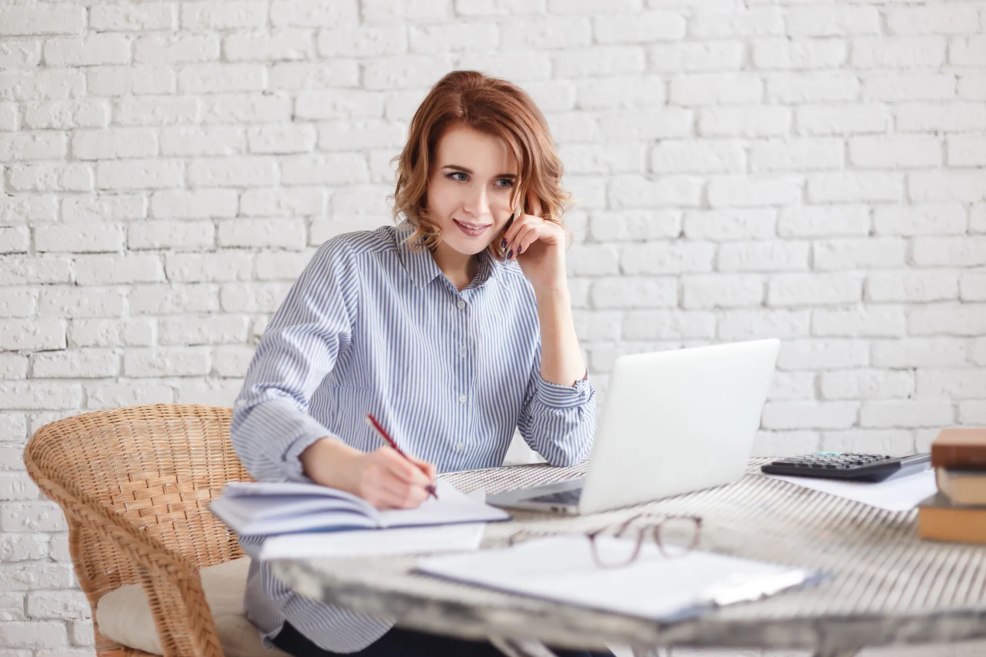 Marketing professional working on a laptop at home