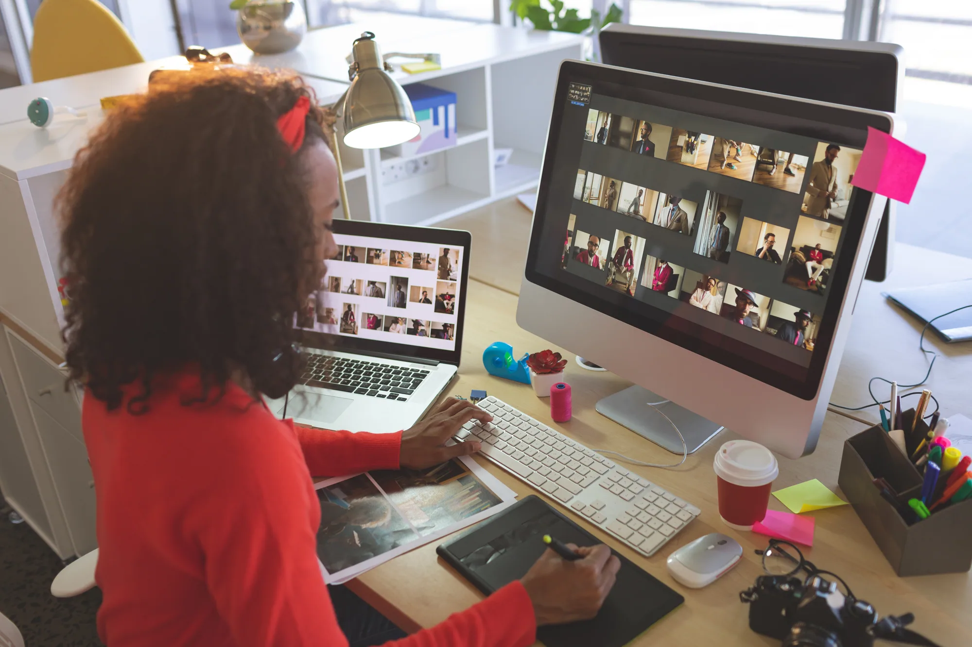 Social media creative working on images and content on desktop monitors