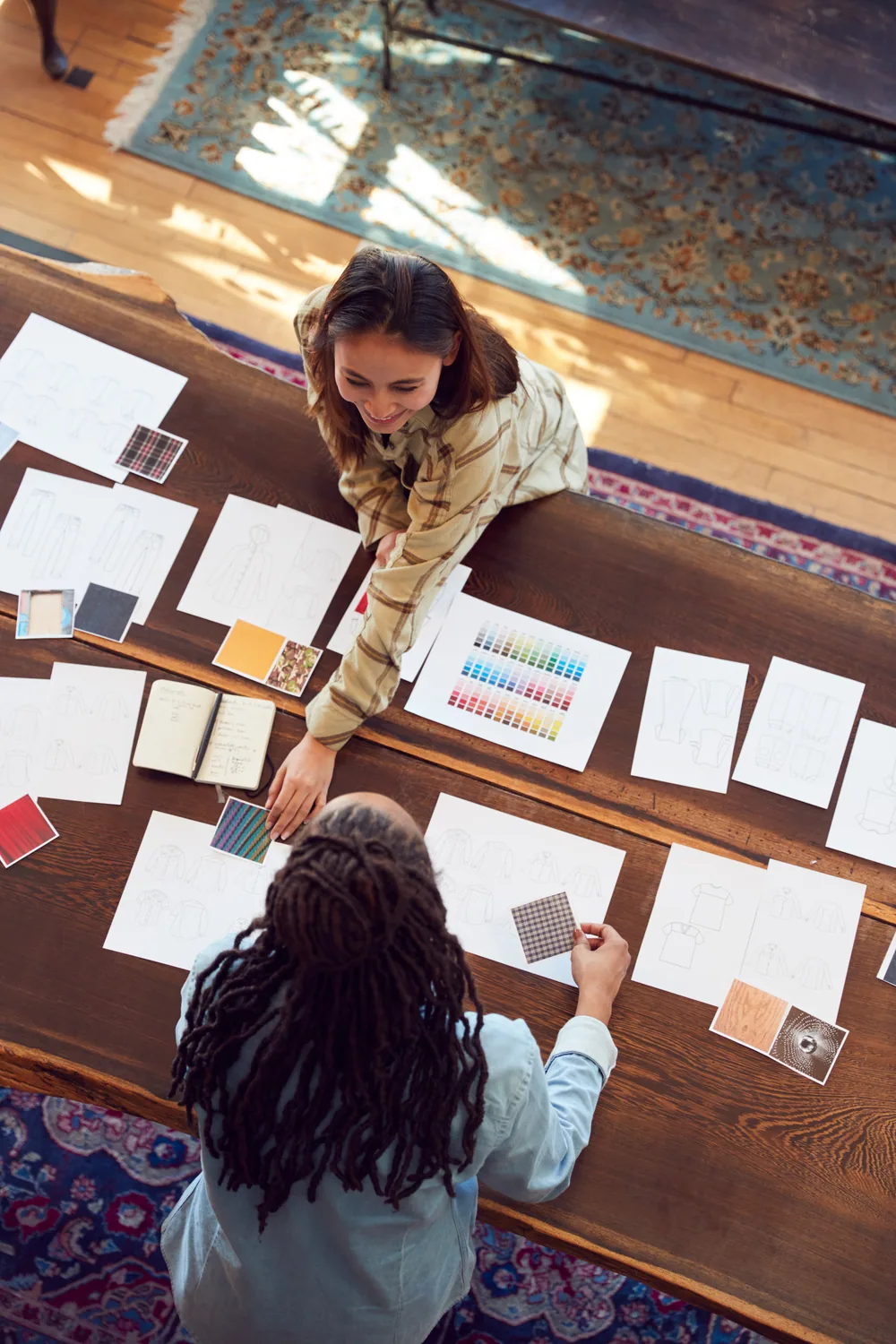 Fashion brand collaborators reviewing a collection together