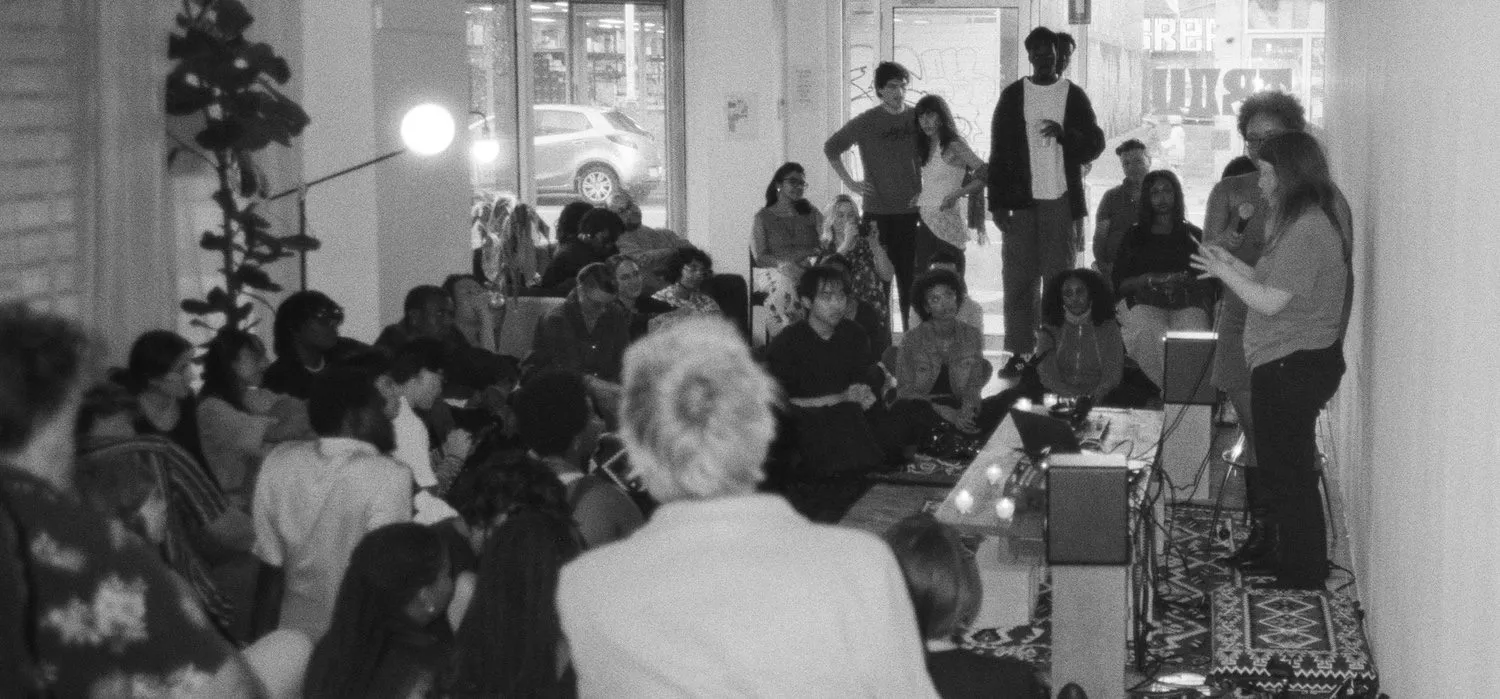 A full room listening to a reading at TROU Space
