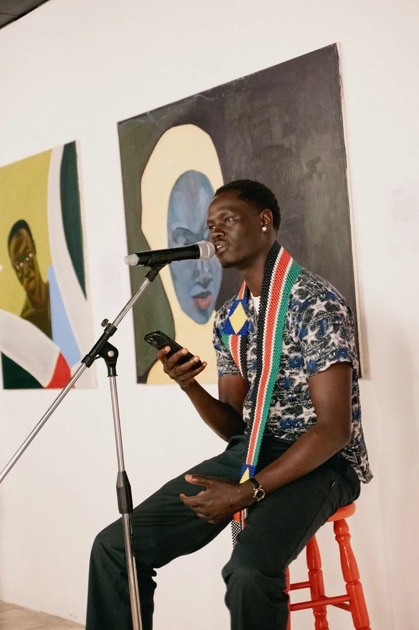 A poet performing to a packed room at TROU Space