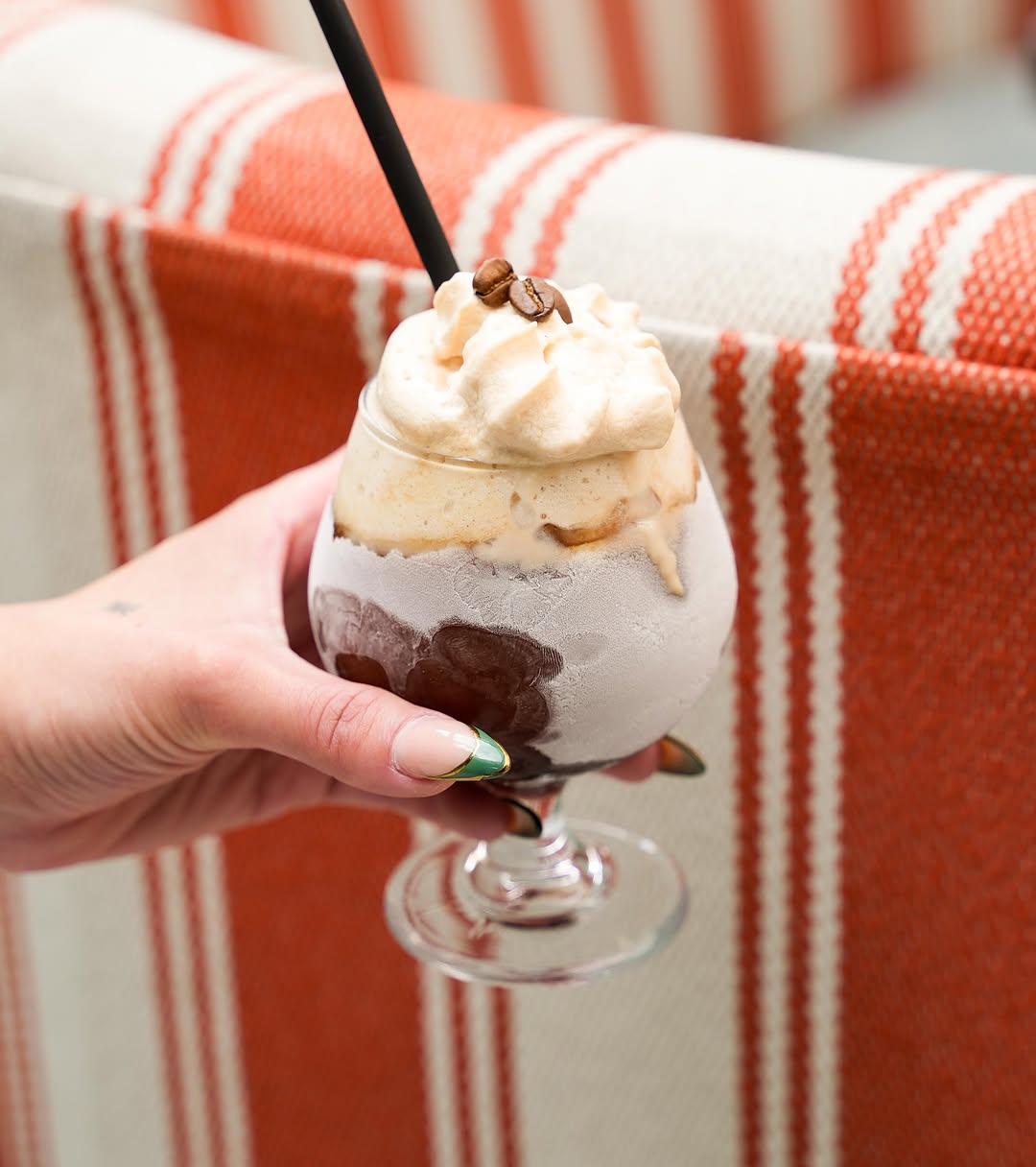 A frozen coffee against the striped banquette