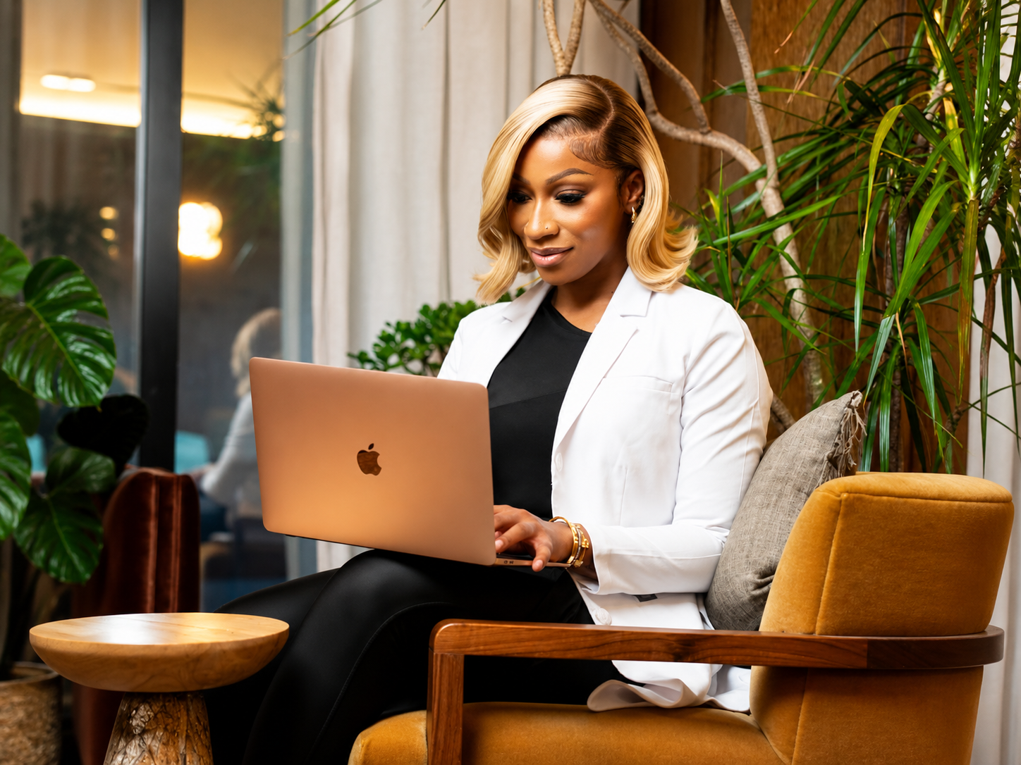 Dr. Arielle working on a laptop in an armchair