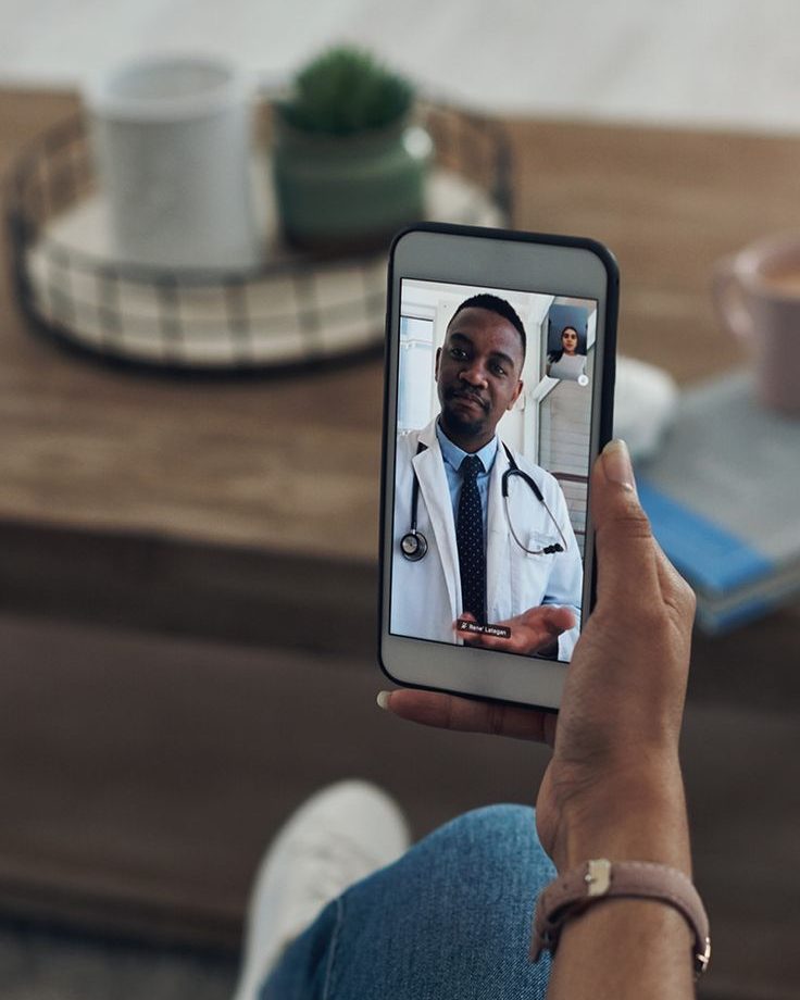 A patient on a video visit with a provider on their phone
