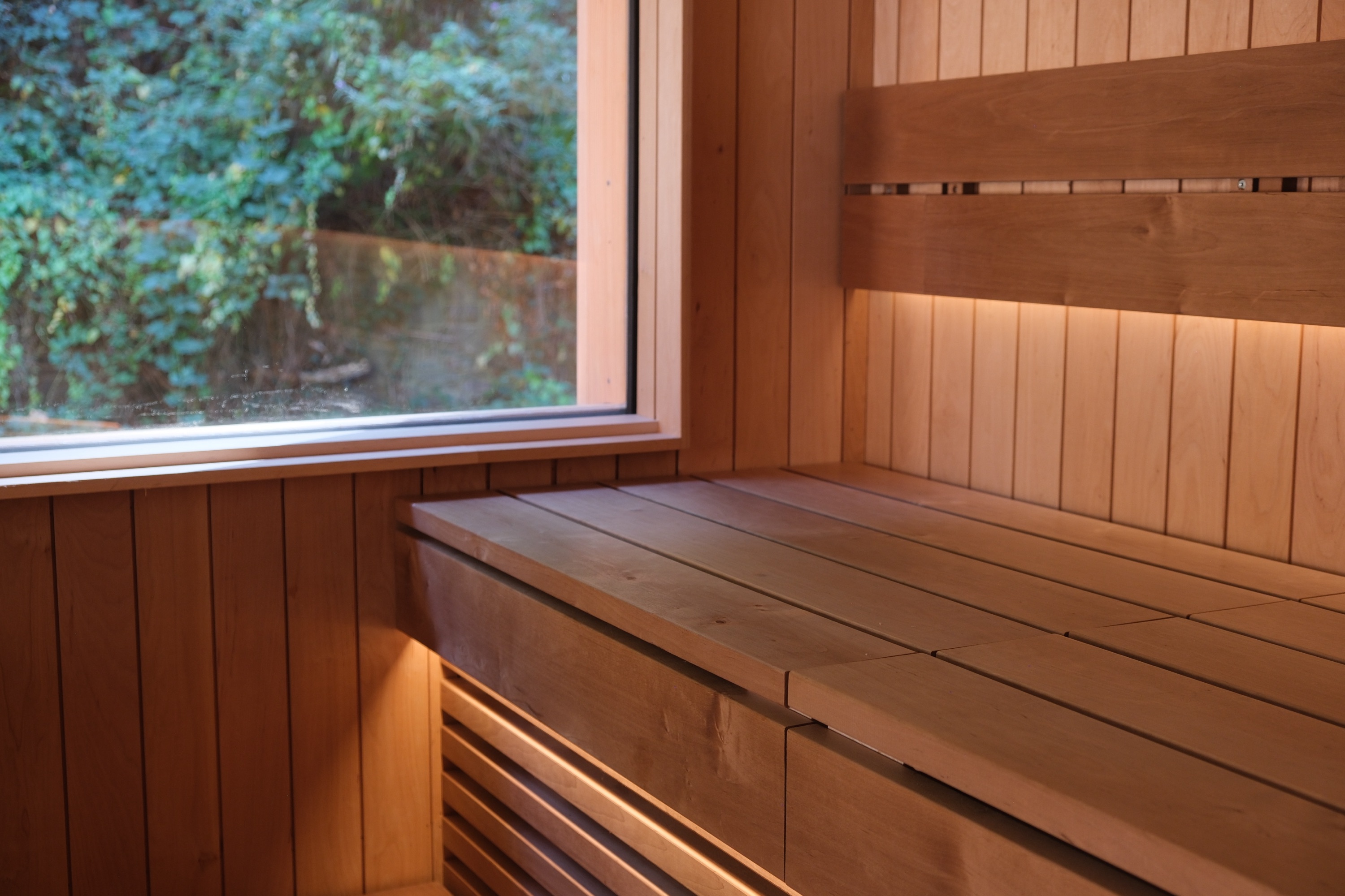 Soft, low-glare lighting inside a timber sauna