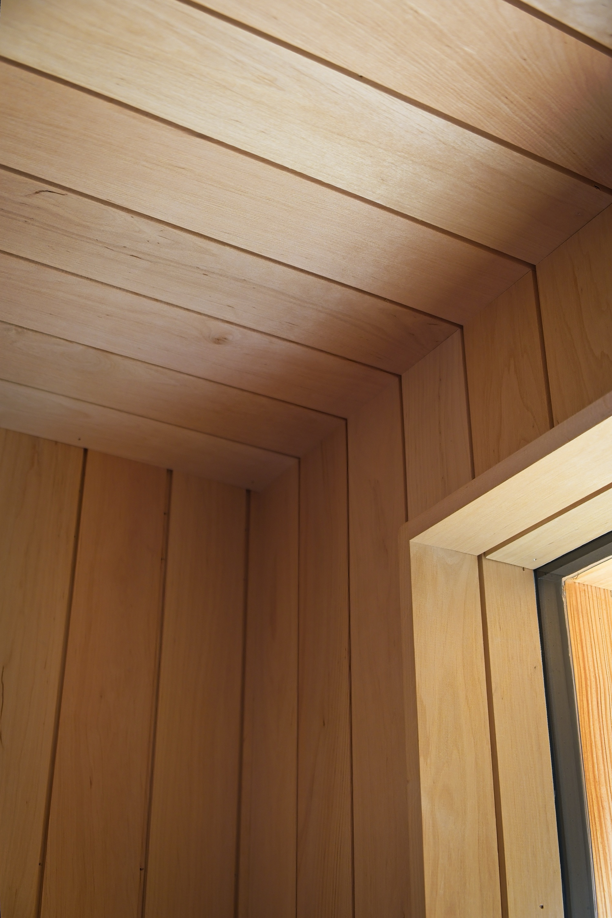 Precise alder joinery and shadow gaps inside the sauna