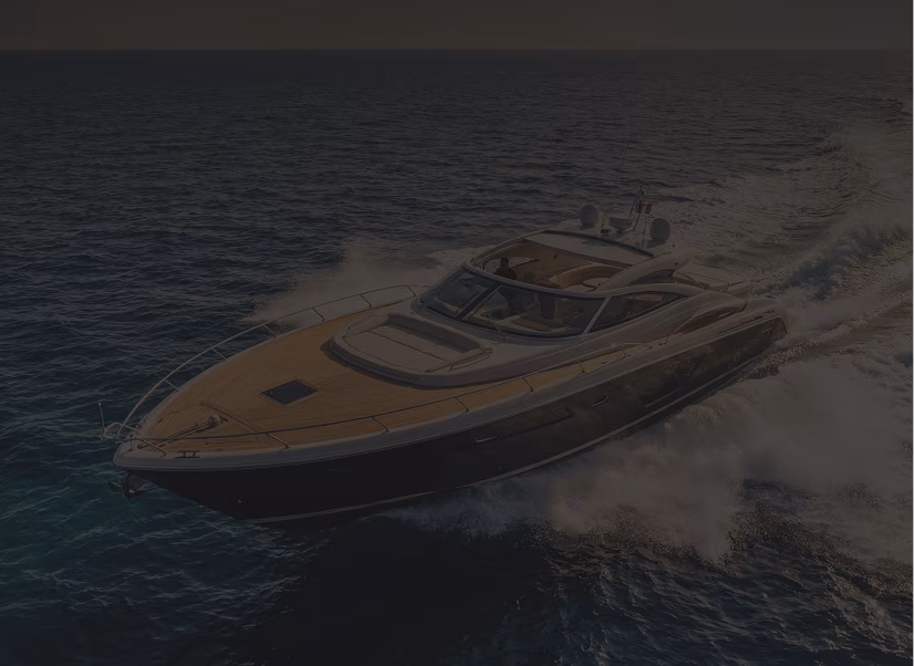 Luxury motor yacht cruising fast on blue ocean water, creating white waves, viewed from above.