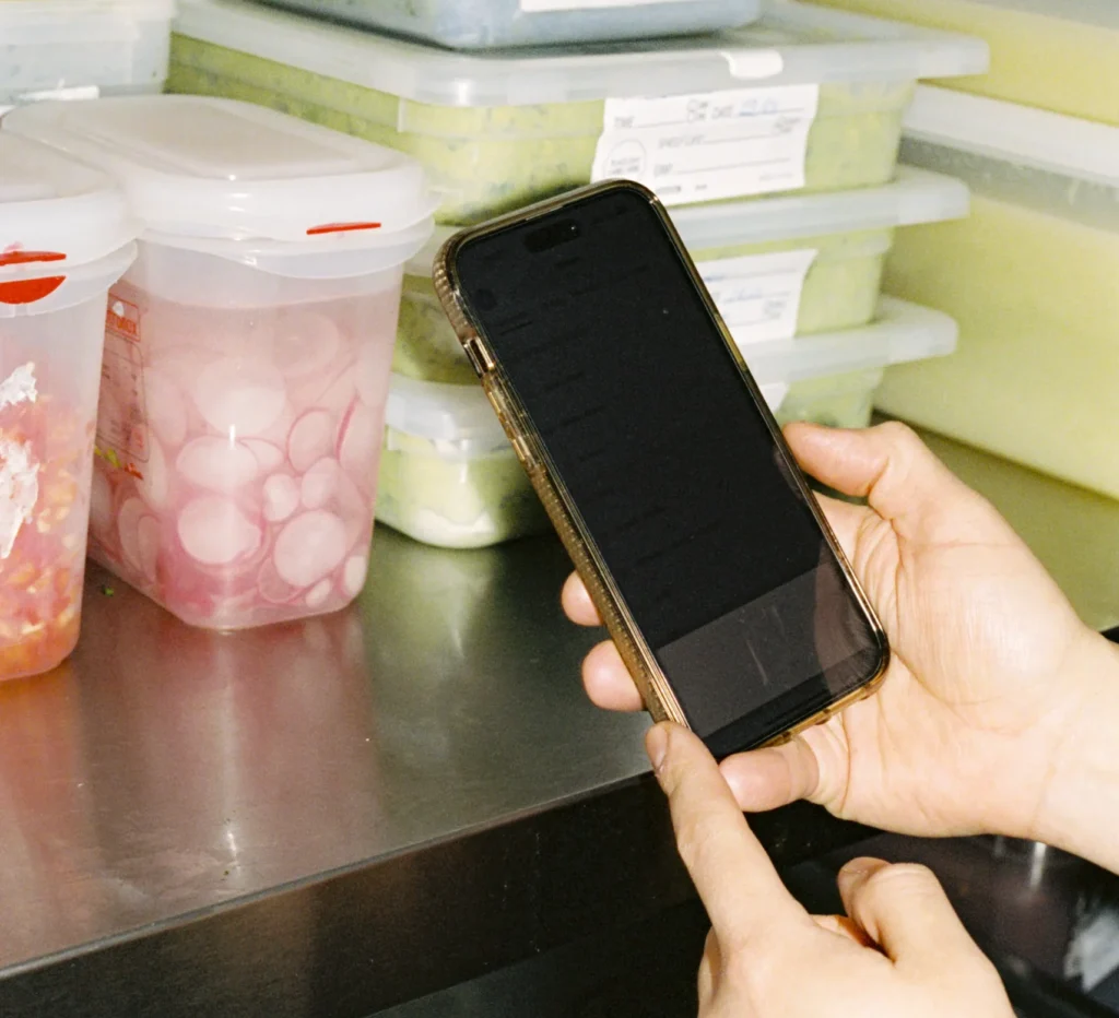 Employee checking the cost of inventory with Nory