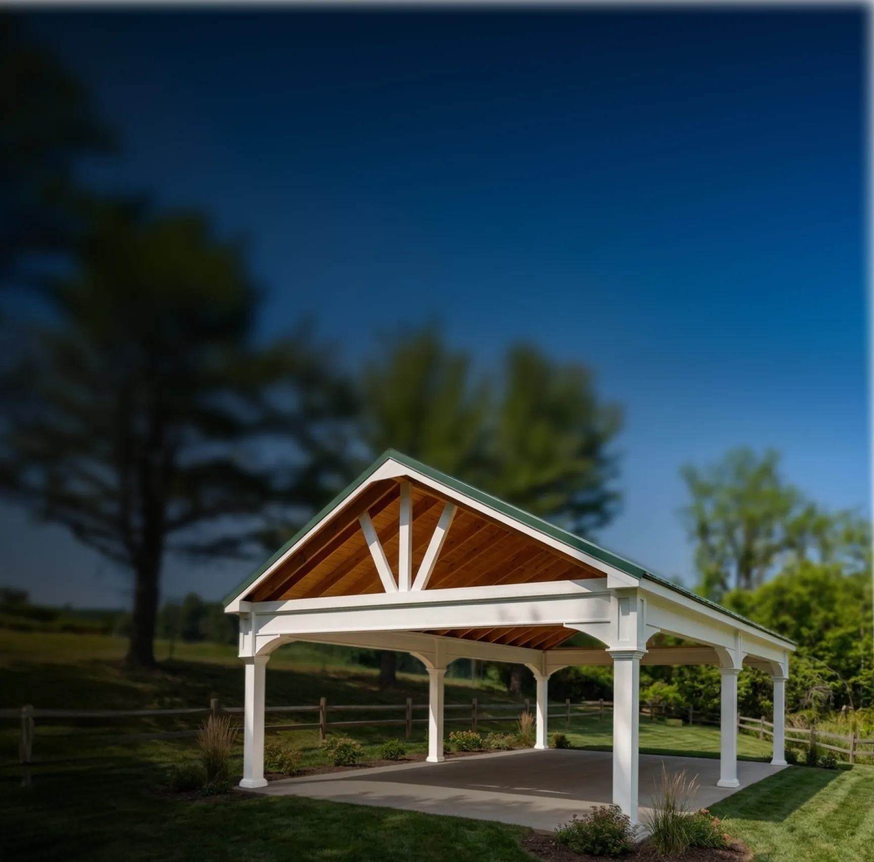 An open-air pavilion with a white frame and a gabled roof set in a grassy yard.