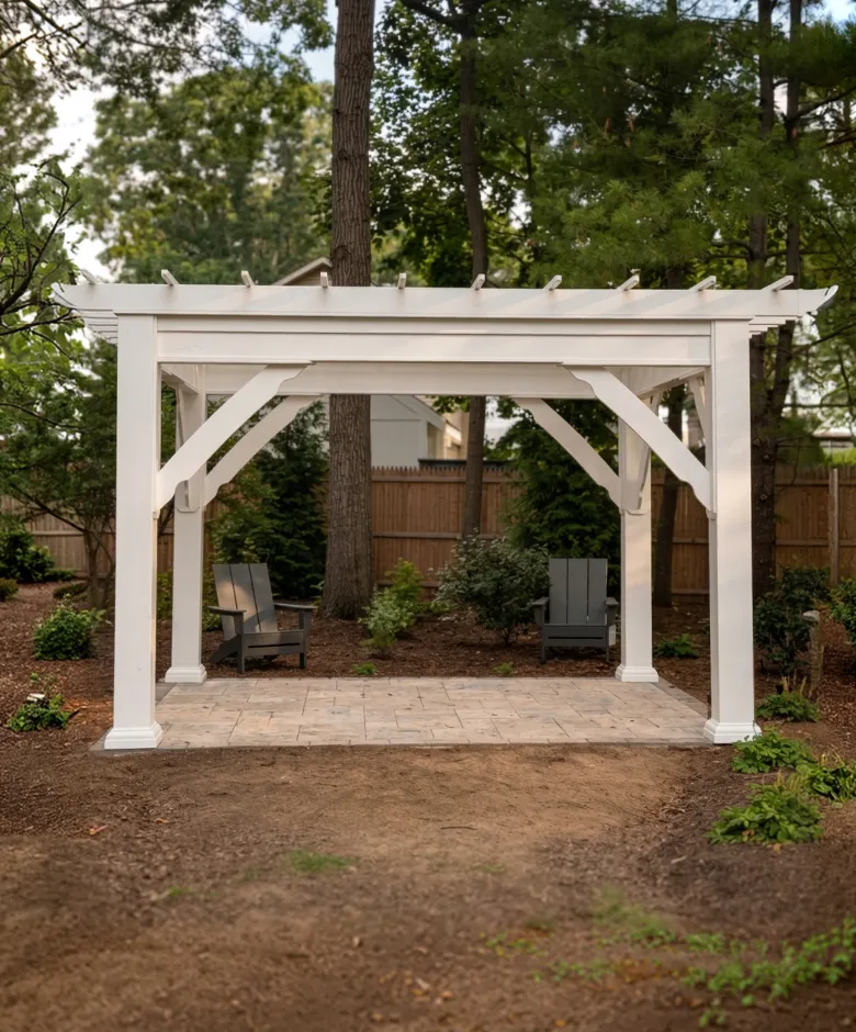 White wooden pergola over a stone patio.