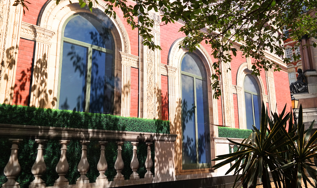 Close-up of printed arched windows, brickwork and decorative balustrade at the Royal Albert Hall.