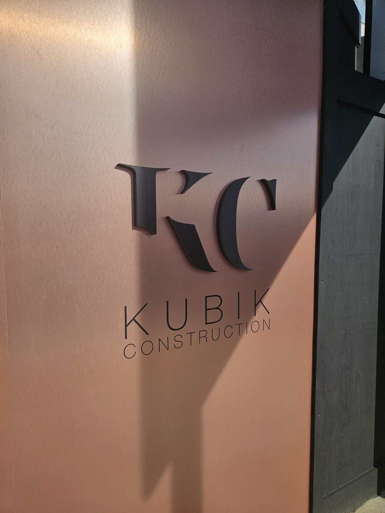 Kubik Construction branding and lettering on completed bronze hoarding