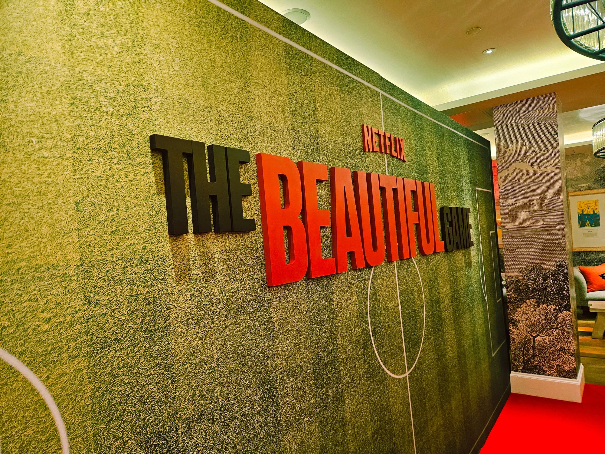 Netflix MAN VS BEE blue scenic backdrop with dimensional lettering
