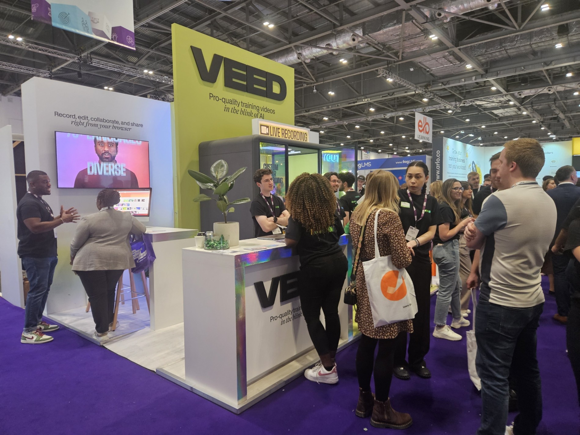 Visitors interacting at the VEED exhibition stand at Learning Technologies