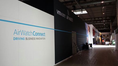 AirWatch exhibition interior with Business Mobility graphics, demonstration stations and meeting furniture