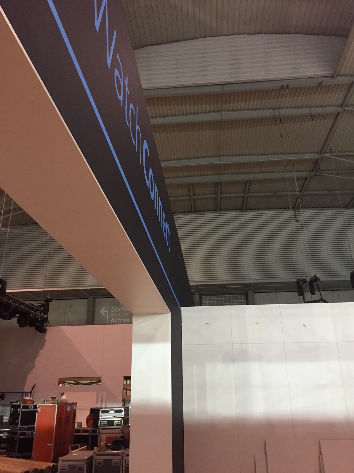 AirWatch Connect exhibition stand during installation, showing black branded walls, seating and access equipment