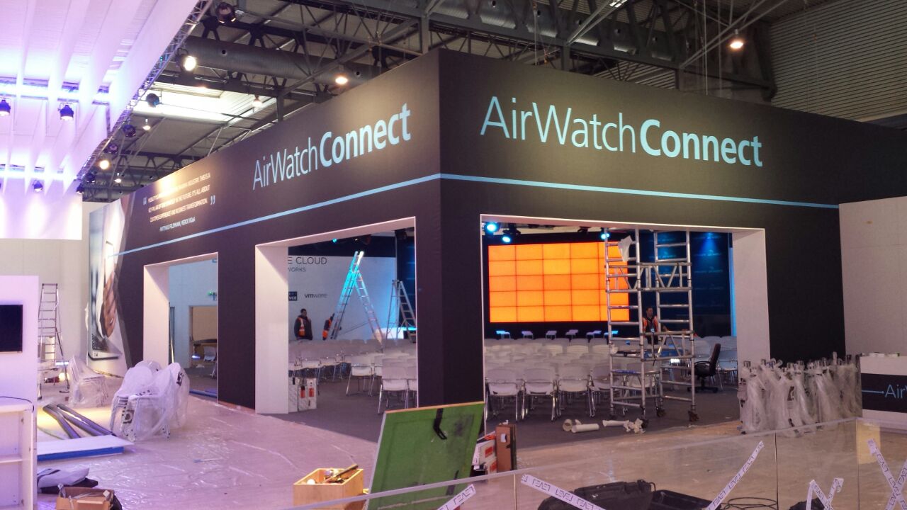 Side view of the AirWatch exhibition wall during construction, with large Innovation graphics and exposed exhibition hall