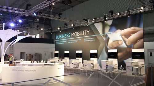 VMware AirWatch suspended overhead branding with illuminated underside above the exhibition stand