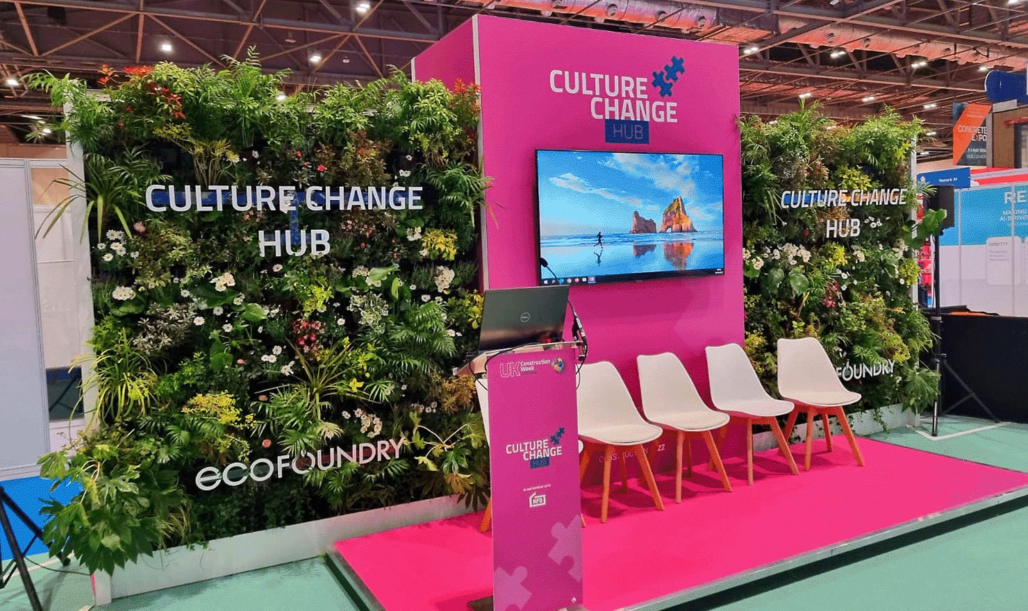 Culture Change Hub pink event display framed by living walls