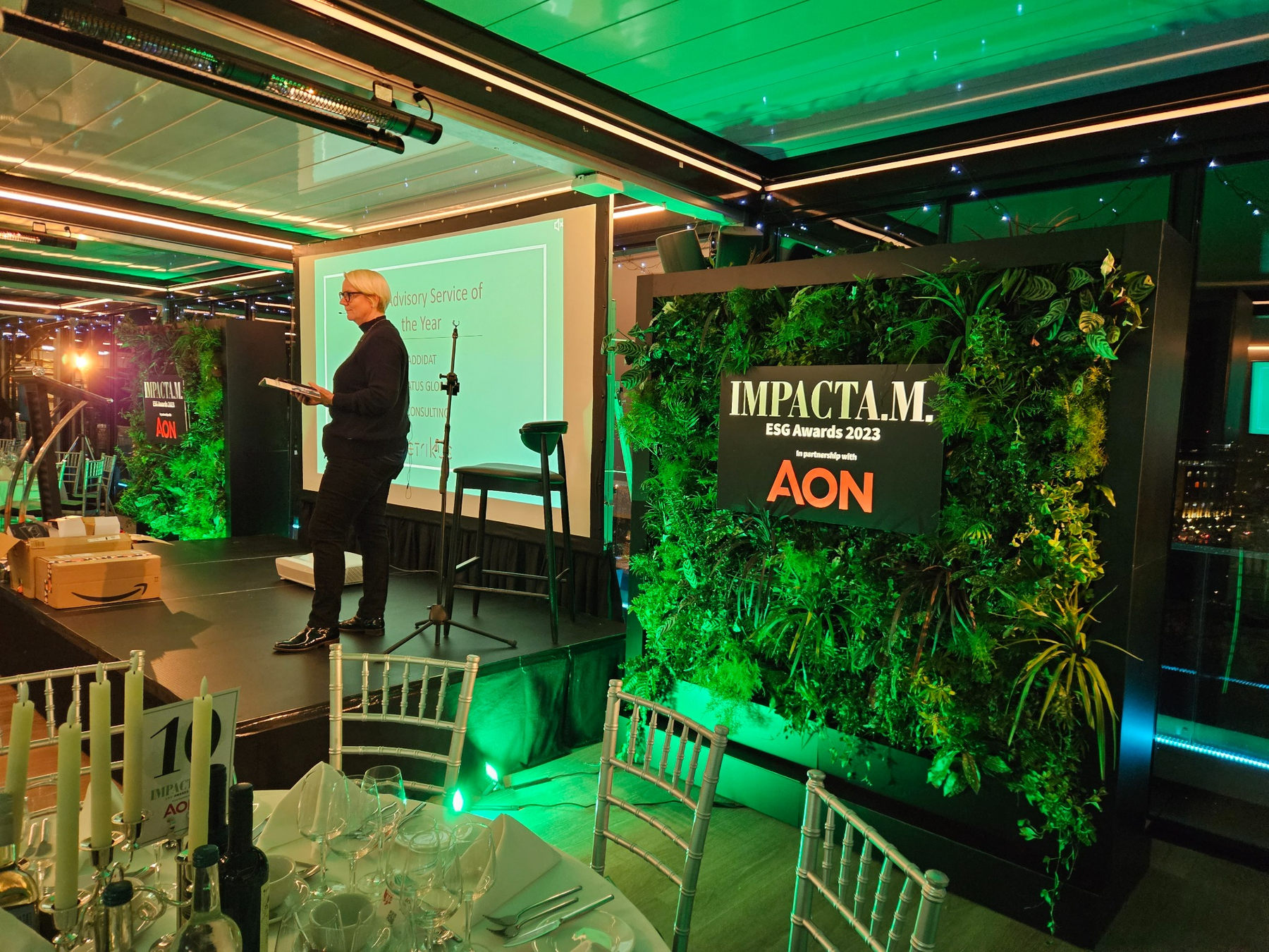 Impact A.M. ESG Awards stage and illuminated planted backdrop