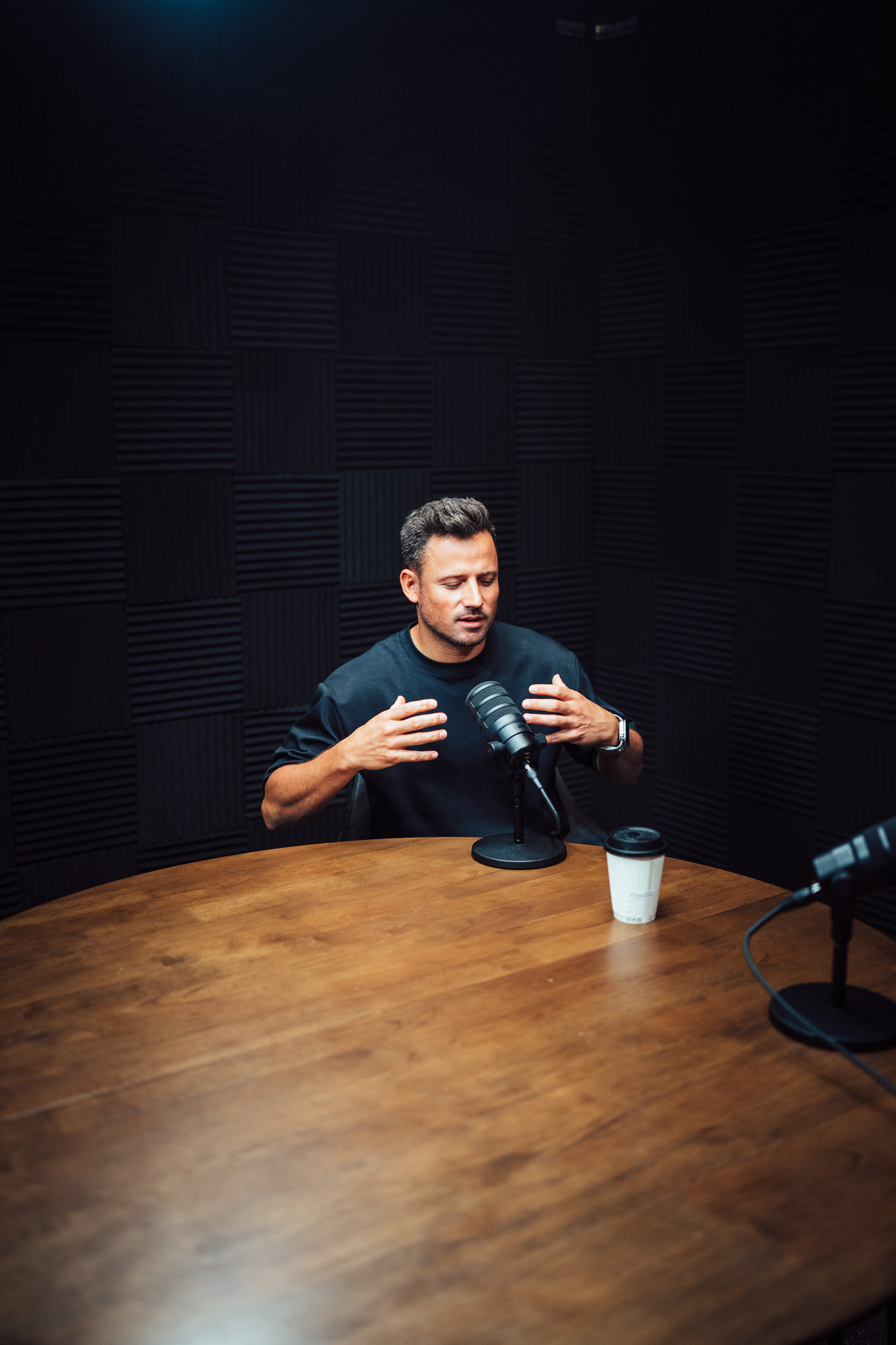 Joost Narraina recording content in a podcast studio