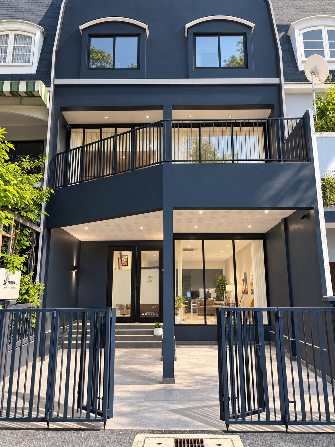 The navy blue Just for Creators studio house on Chaiyaphruek Yaek 8, Bangkok, seen from the street