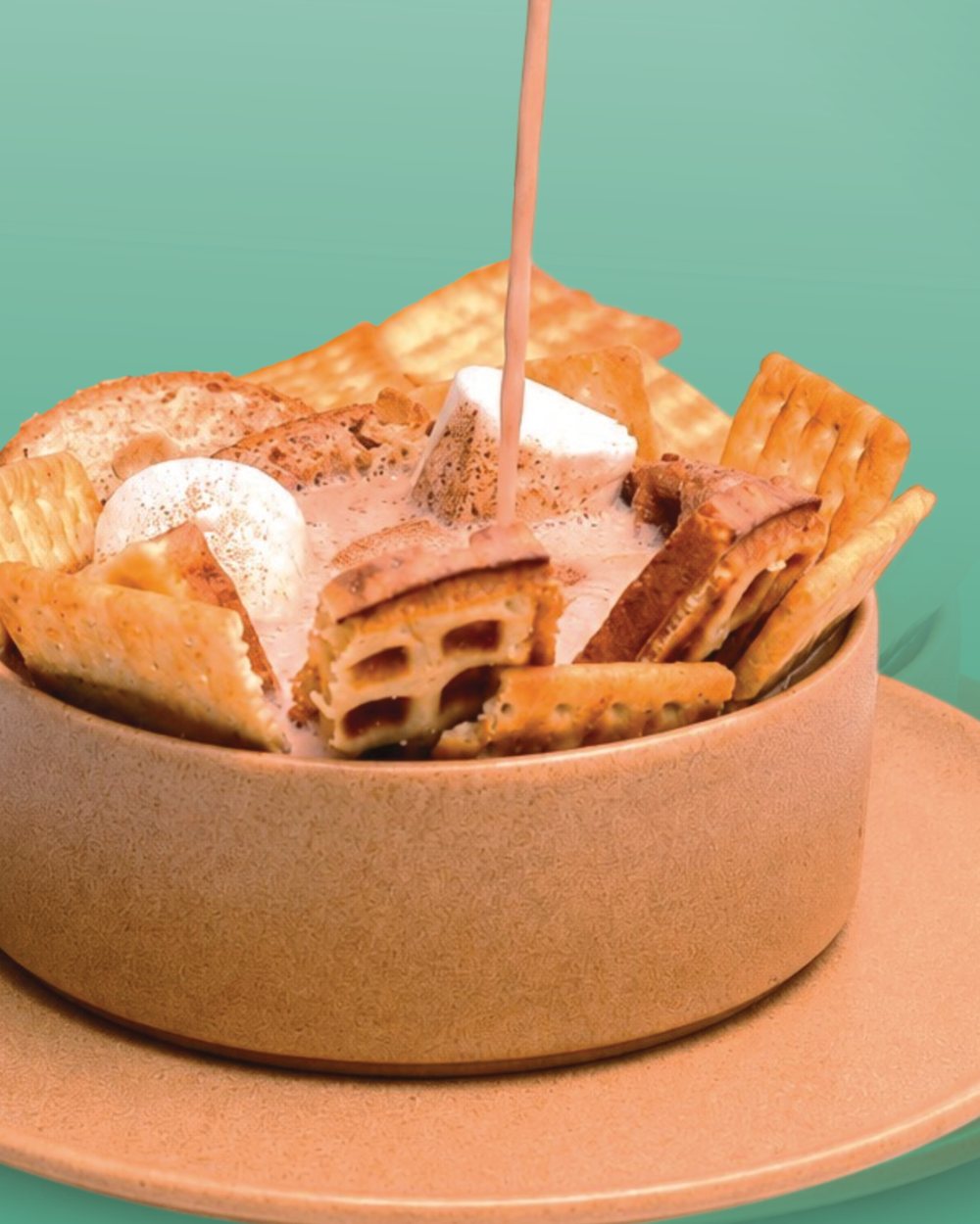 Migao: chocolate caliente vertido sobre waffle, galletas, queso y masmelos