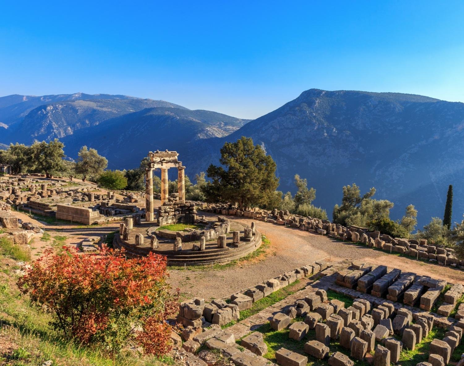 The Tholos at Delphi below the mountains