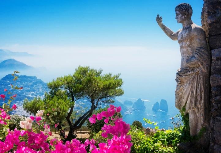 View over Capri with bougainvillea and a statue