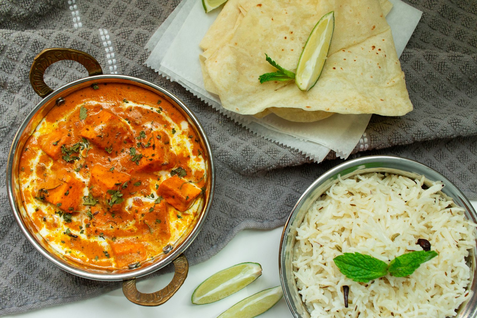 Bowl of curry with rice and flatbread