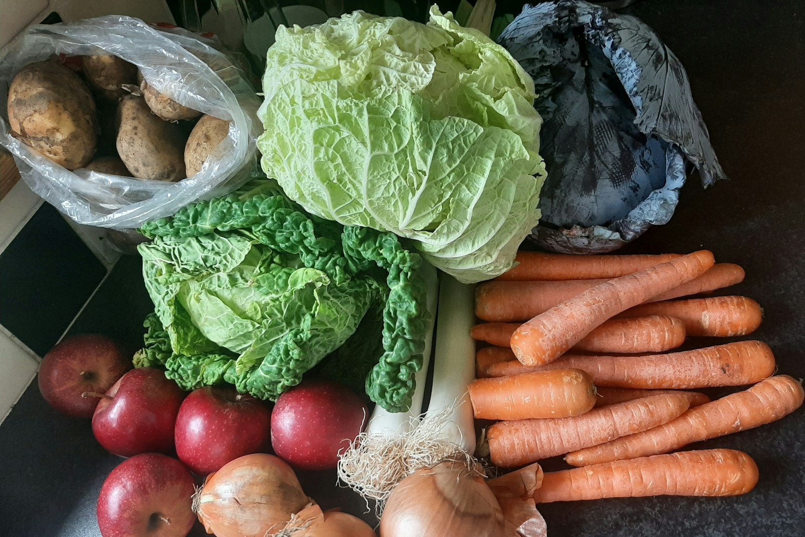 Cabbage, carrots and onions on a table