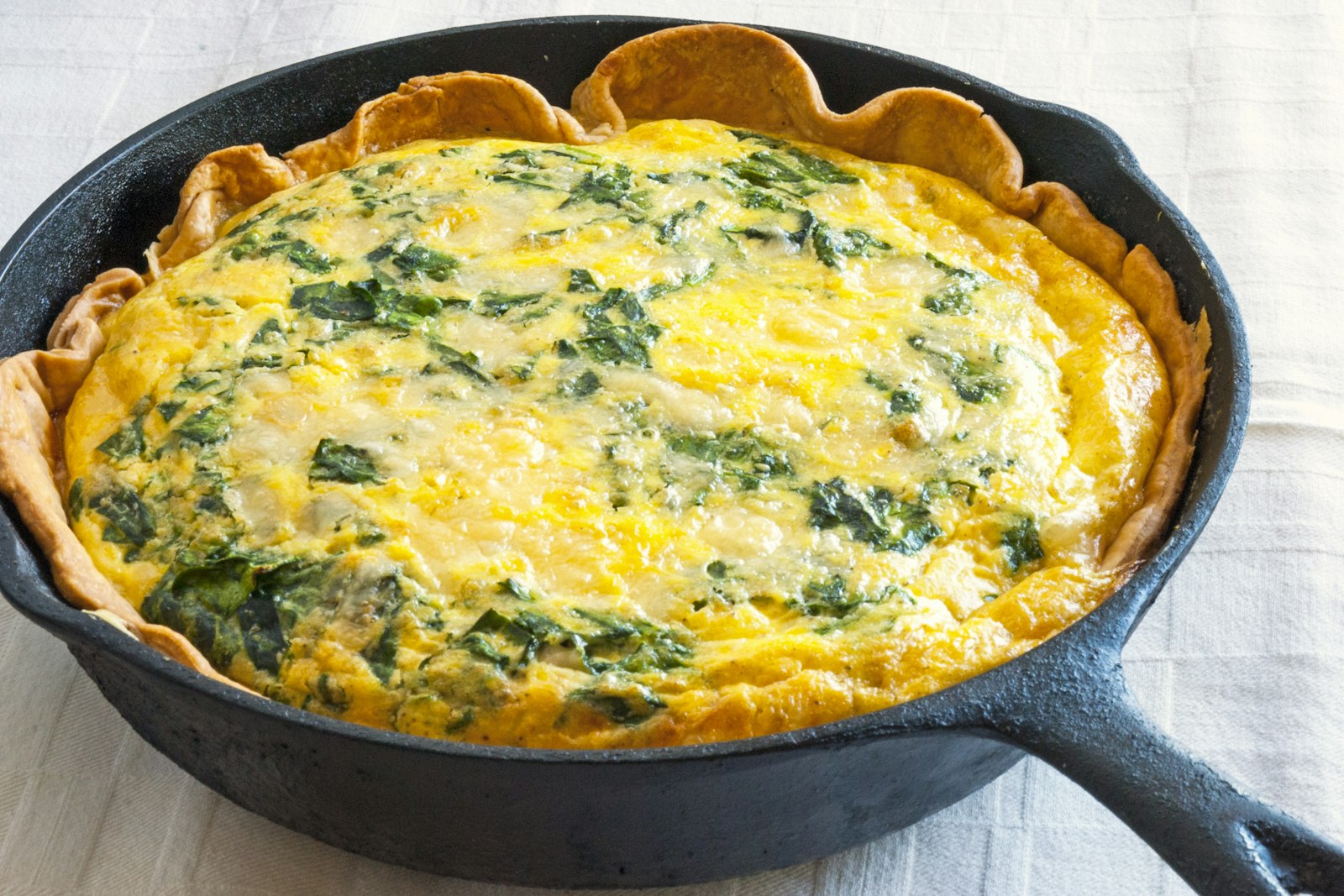 Cheesy spinach bake in a cast-iron skillet