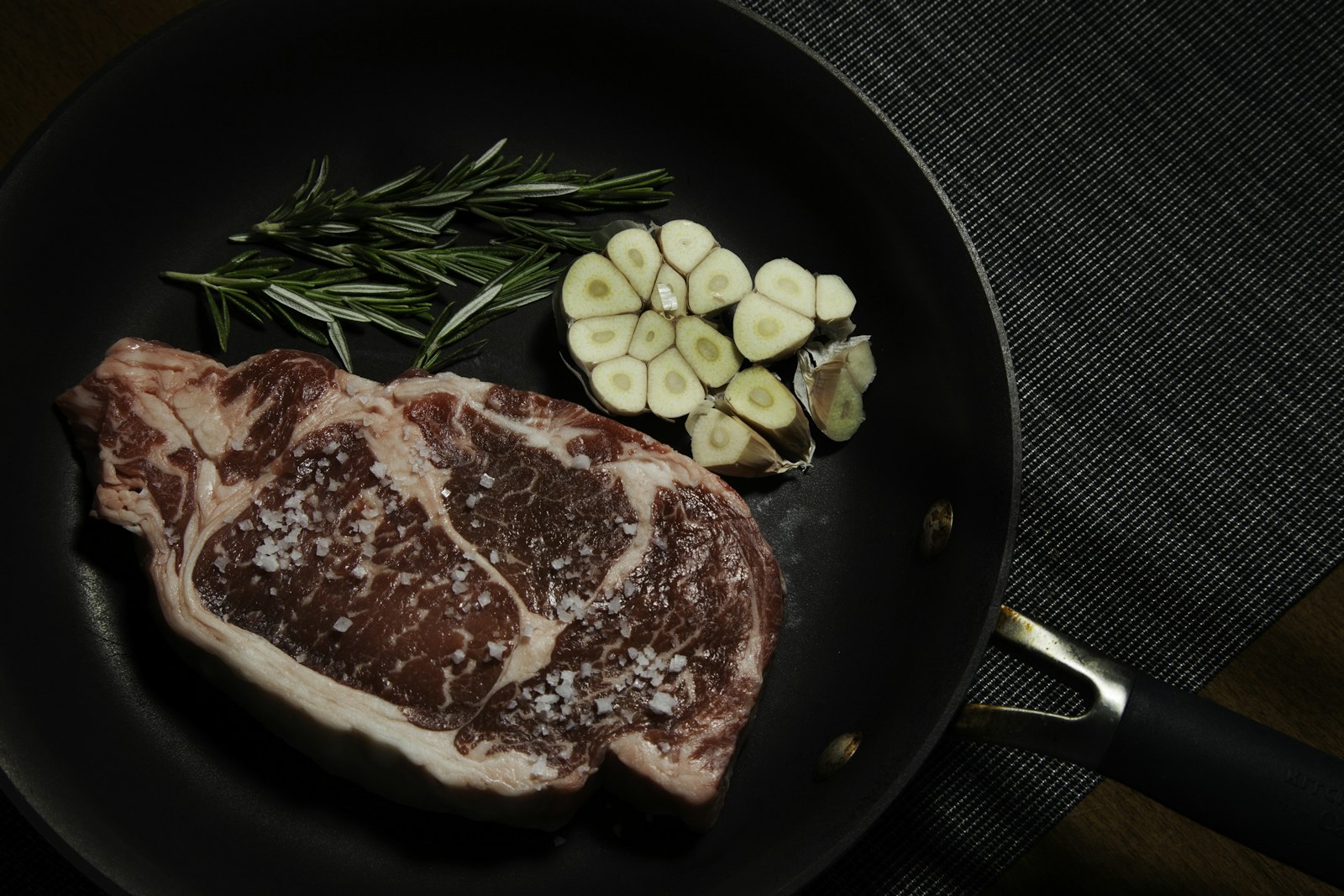Steak in a cast-iron skillet with garlic and rosemary