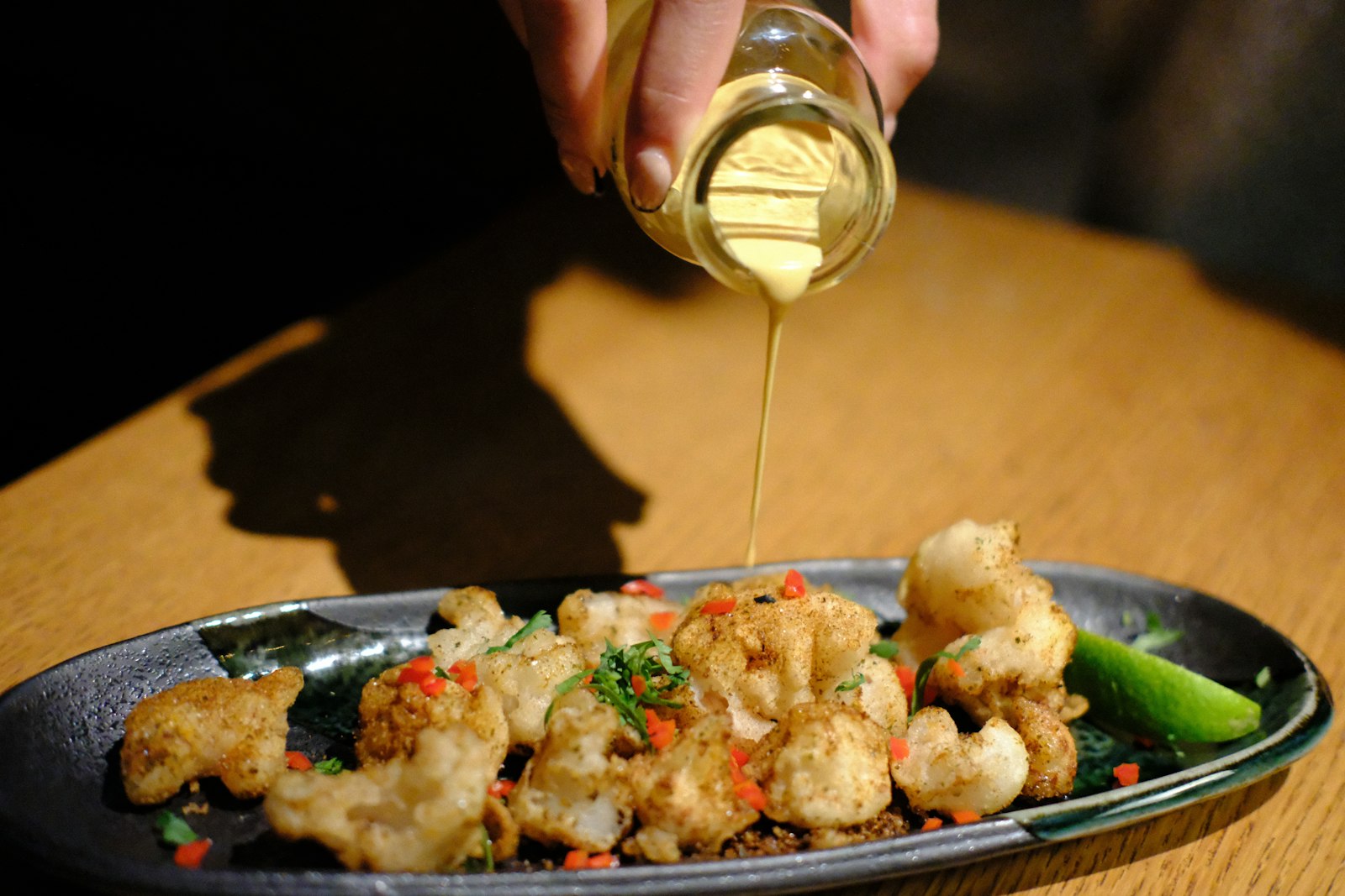 Oil drizzled over roasted cauliflower