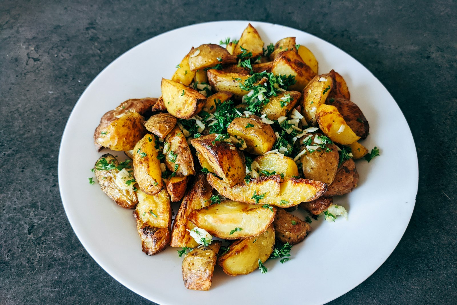 Roasted potatoes with herbs on a plate