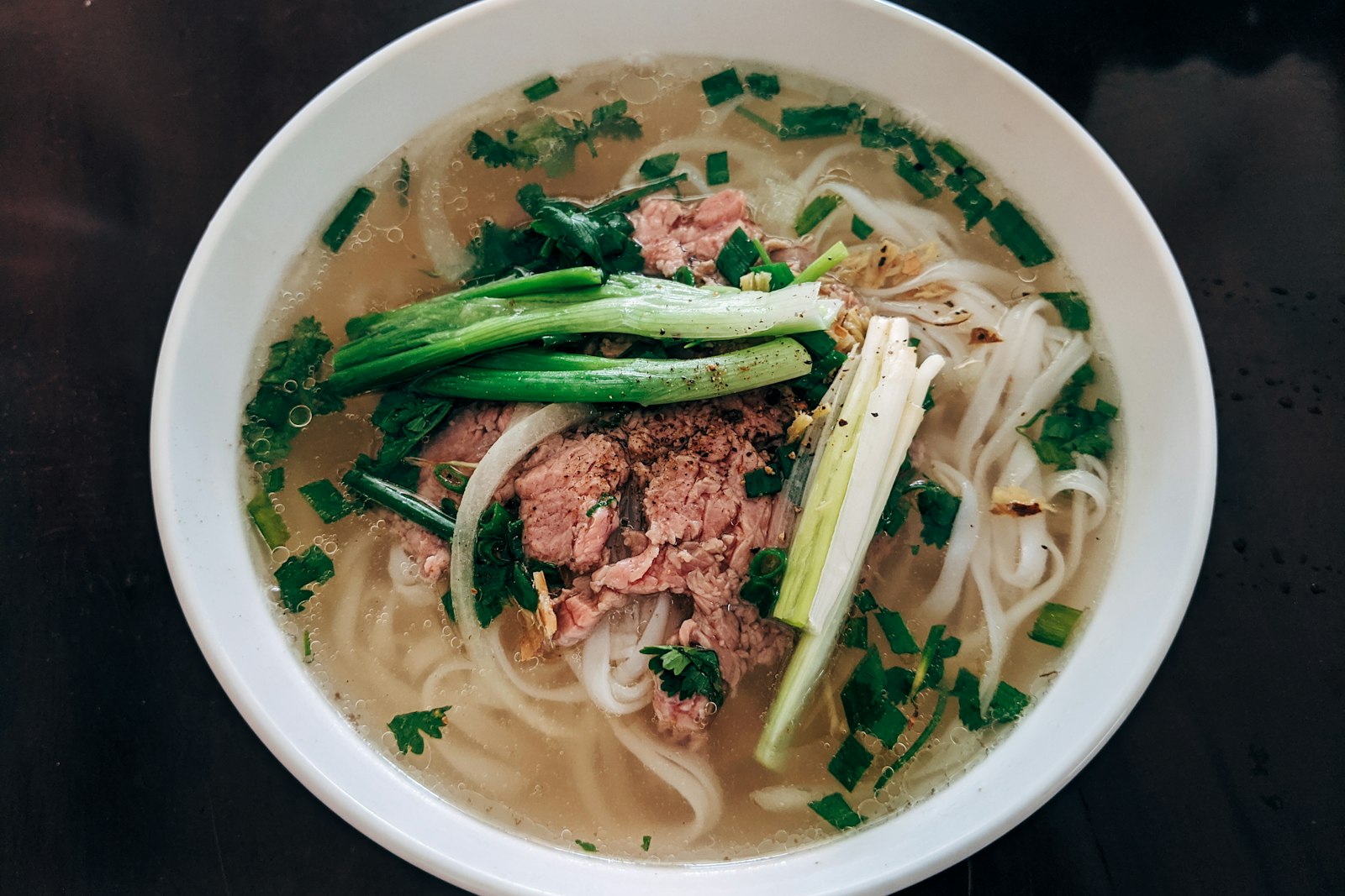 Bowl of pho with herbs