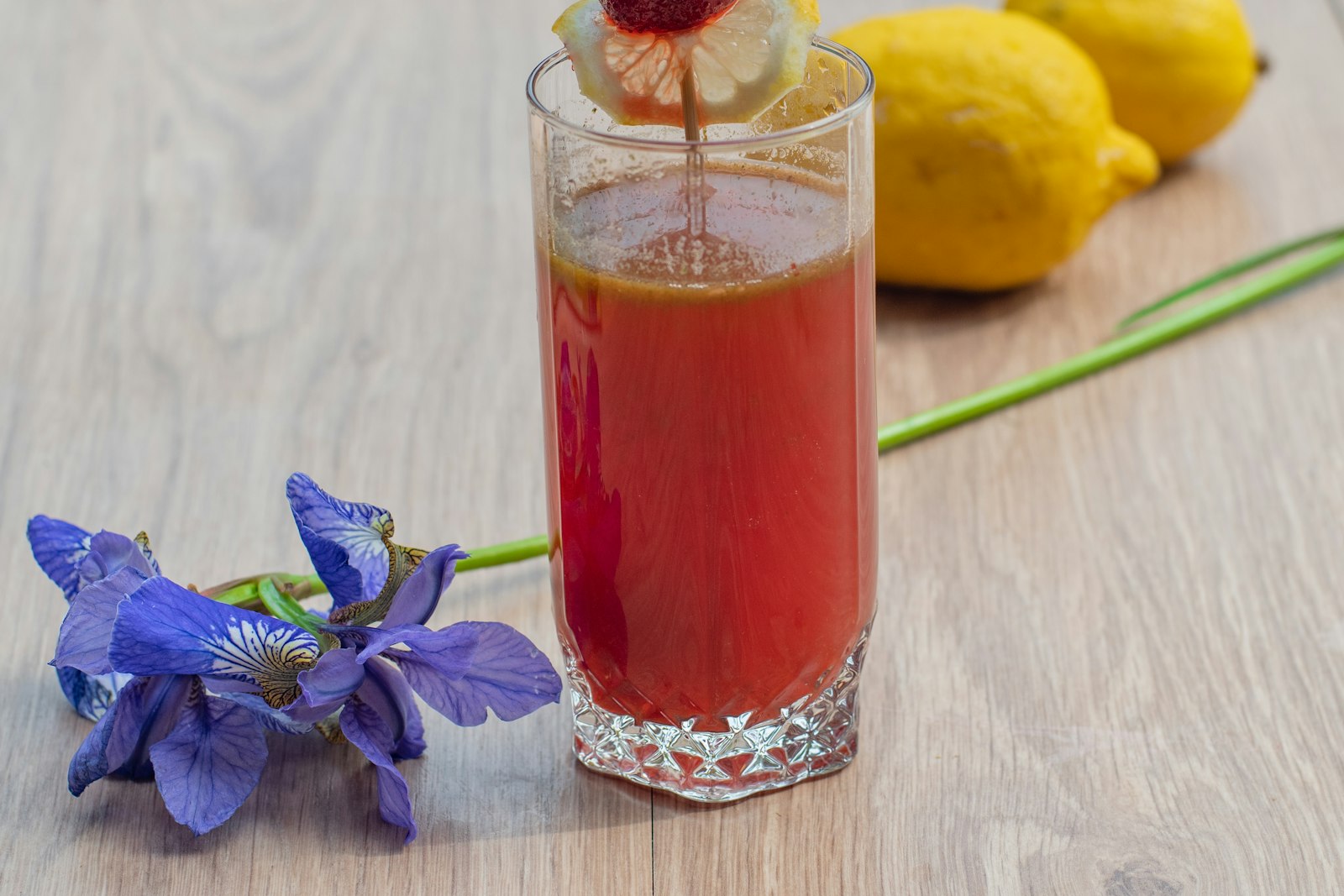 Glass of pink lemonade with lemons