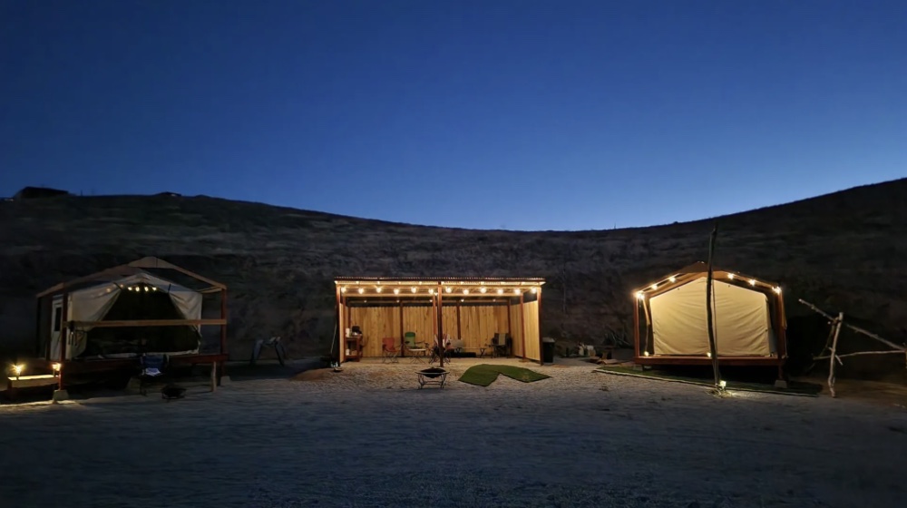 Camp lit up at dusk